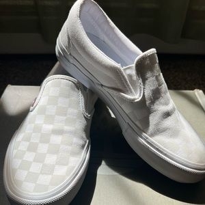 White slip on vans with reflective checkers